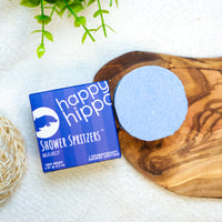 Happy Hippo Shower Spritzer packaging with a spritzer on a wooden board