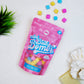Unicorn Poop happy hippo mini bath bombs with colorful bath bombs on a white surface.