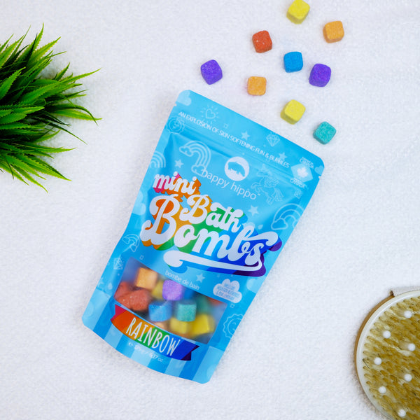 rainbow mini bath bombs bag on a white surface.