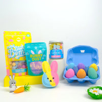 Assorted Easter-themed bath products including mini bath bombs and easter egg bombs on a white background