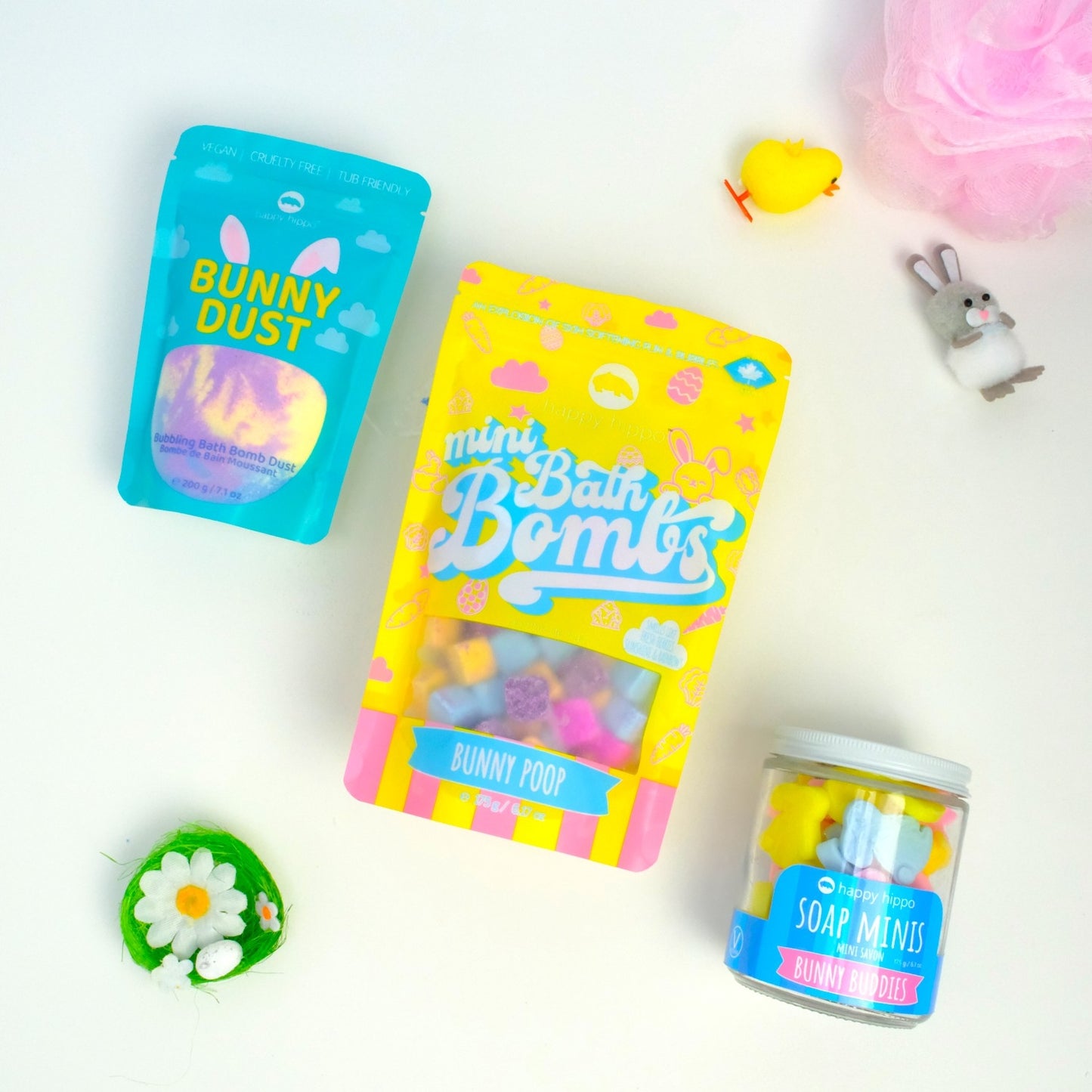yellow bunny poop mini bombs bag, blue bunny dust bag, and bunny buddies mini soap jar on a white background