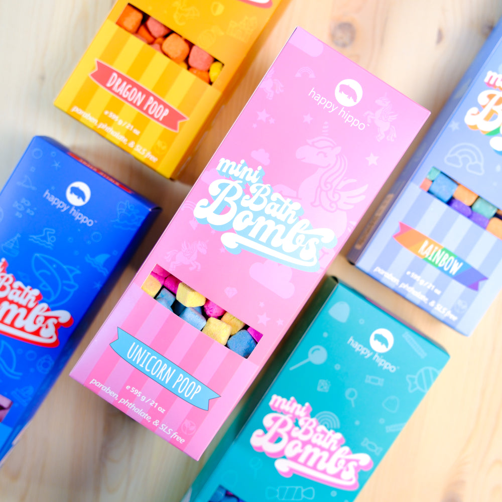 Colorful boxes of 'mini Bath Bombs' with branding on a wooden surface