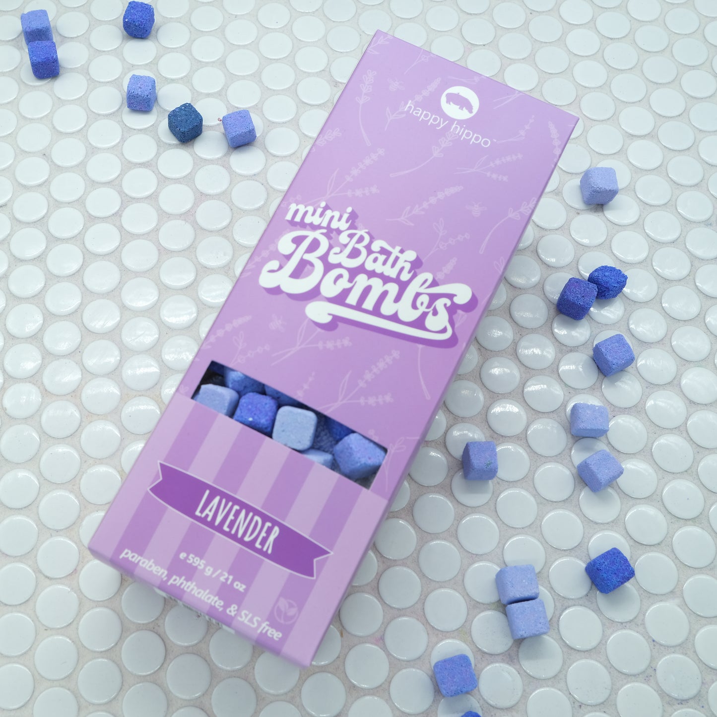 Purple box of Lavender Mini Bath Bombs on a white background with bath bombs scattered around it