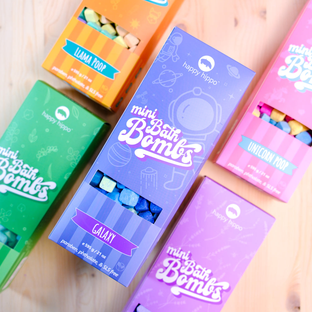 Colorful boxes of mini bath bombs on a wooden surface