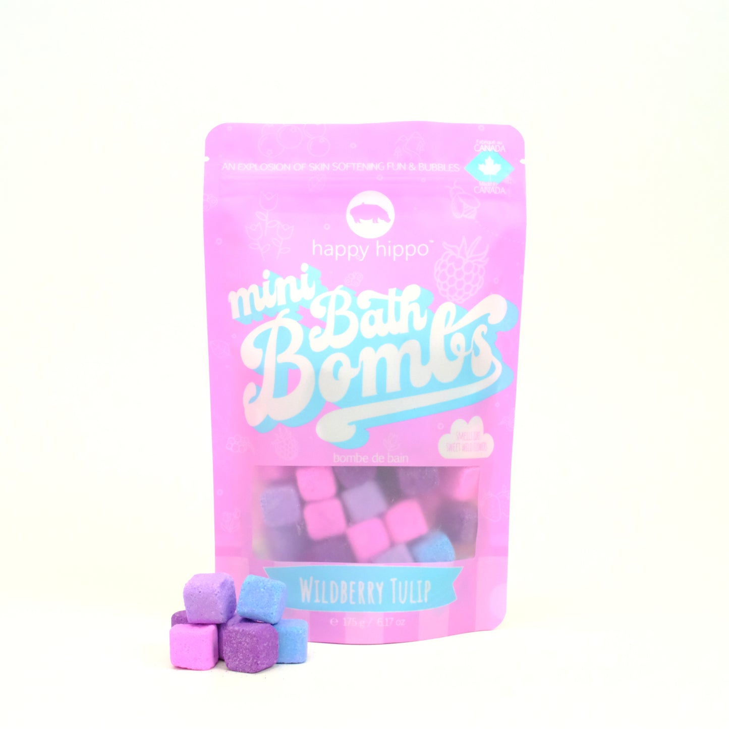 Bag of pink Wildberry Tulip Mini Bath Bombs on a white background with mini bath bombs stacked in front of it. 
