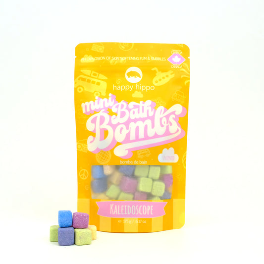 Bag of orange Kaleidoscope Mini Bath Bombs on a white background with mini bath bombs stacked in front of it